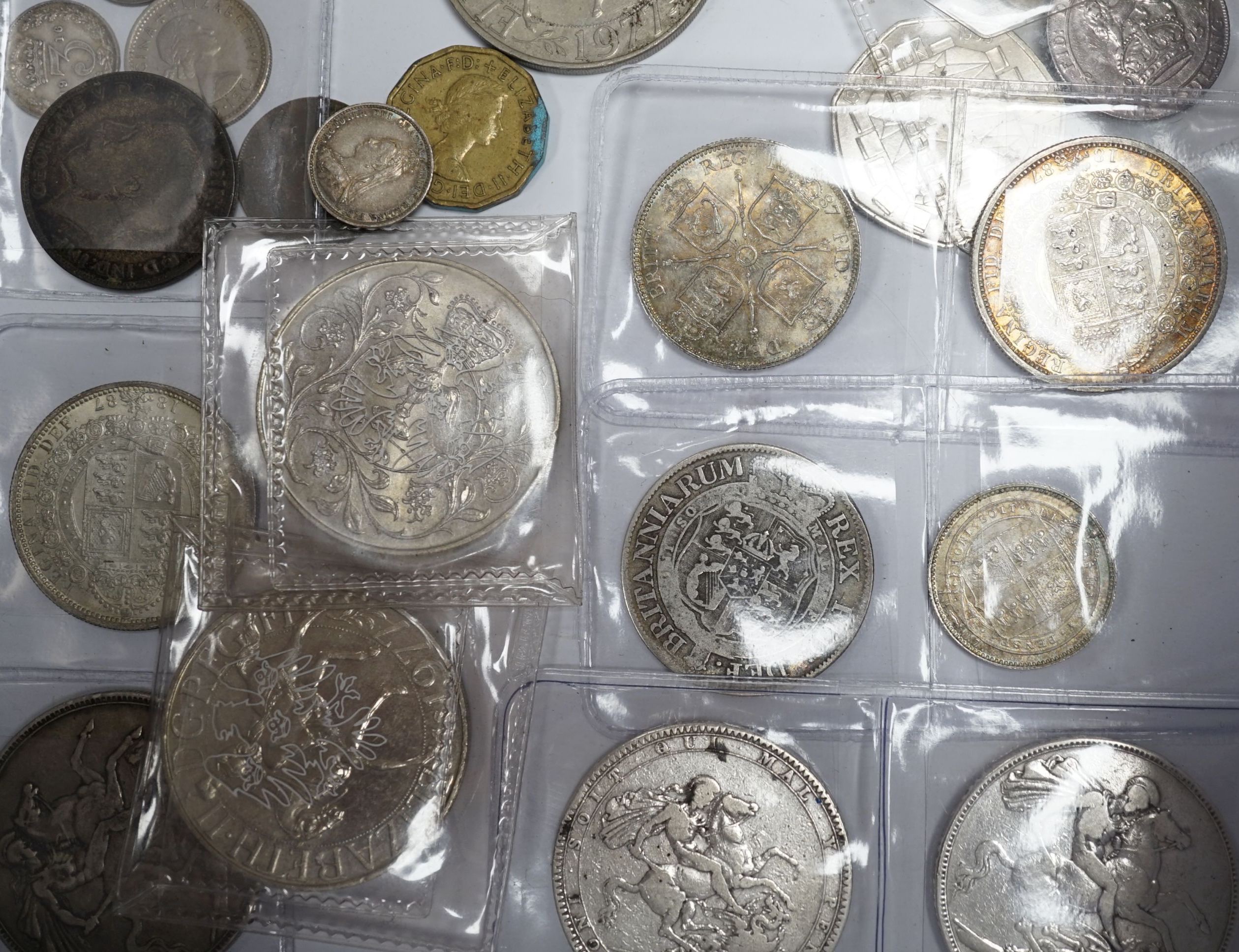 A group of UK coins including 1819, 1821 and 1891 crowns, two 1887 half crowns, 1887 florin, etc.